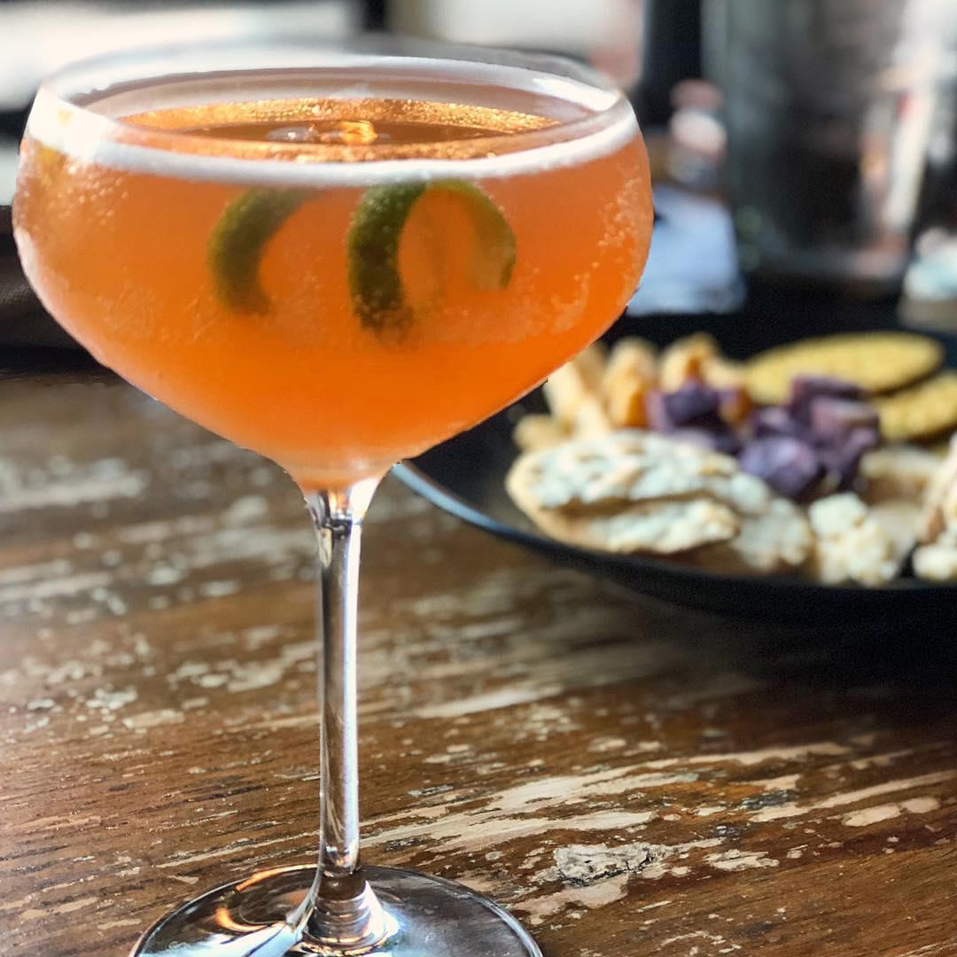 fivefootexplorer shares, "I’m still dreaming of this craft cocktail (and that chive cheddar cheese) from the thehenandthehognc in historic downtown halifaxcvb. It was one of the many highlights from my trip through North Carolina..." 🍸💛
