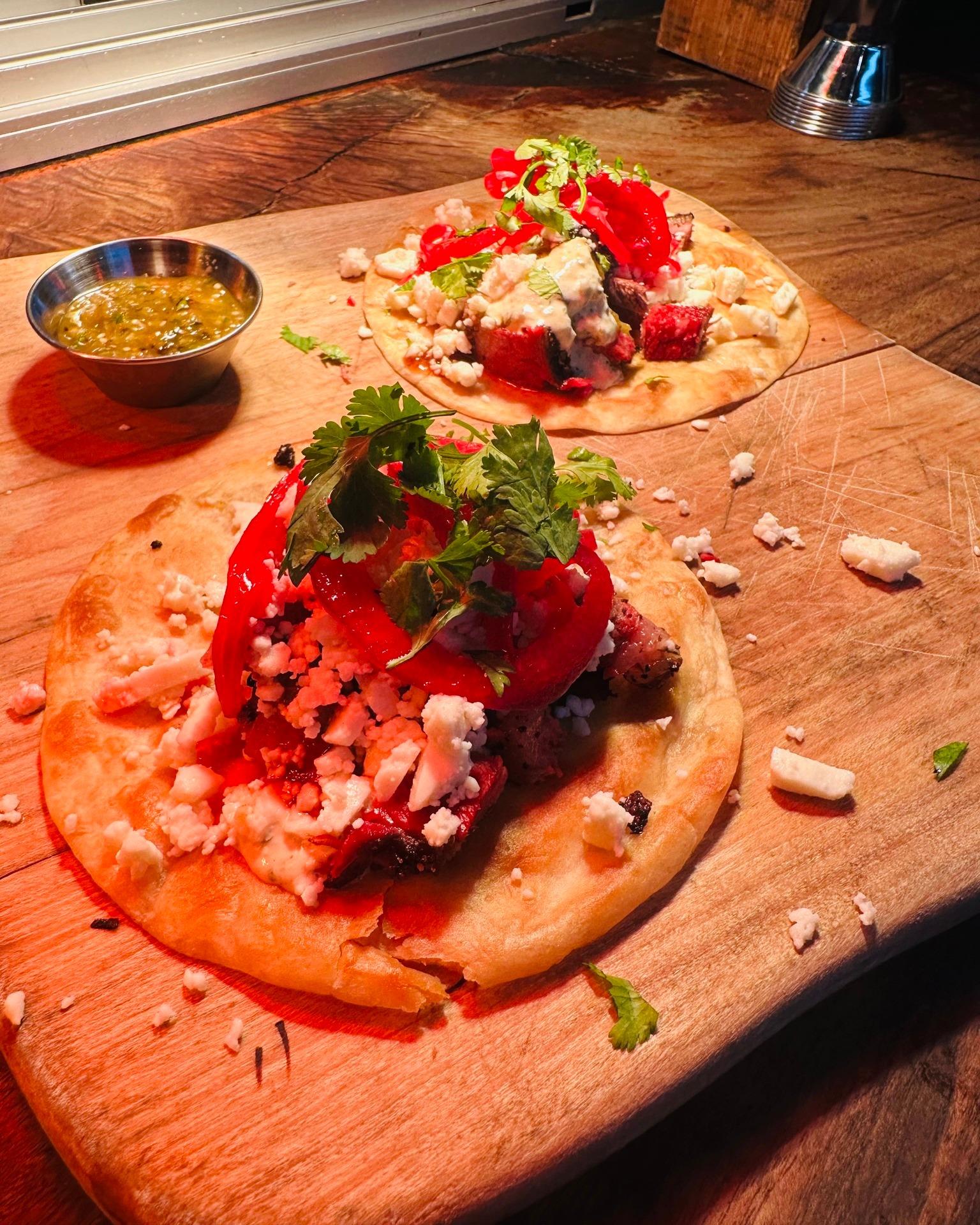 Brisket tacos done right — salsa verde, hatch green chili crema, pickled onions, and queso fresca. No wonder these were such a hit. 🌮🔥