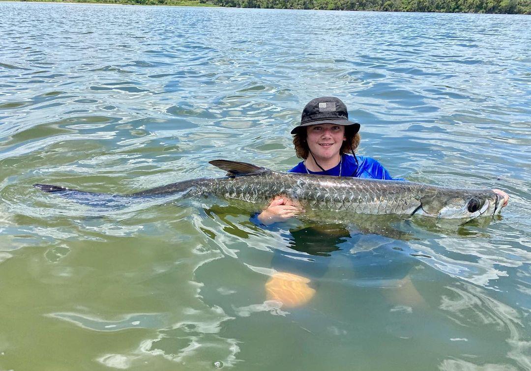 "Well, we got him! Strange fight! Didn’t realize how big he was because he didn’t jump much. But once he did, he made two enormous leaps out of the water and I knew we had a massive lagoon fish on. Jake battled him for 2 hrs on stout tackle and decided to jump in afterward for a quick pic. Didn’t want to lift it out of the water so pic doesn’t do much justice but he was 7+ft long and THICK! Jake’s 200lb and this fish seemed bigger than him. I’m estimating he was around 165, but truthfully I'm not sure. What do you think? The best part was after a good revival I could barely hang onto him and he swam off very strong. Today was one of those days." 
📸 @close_encounters_fishing at Mosquito Lagoon
#LoveNSB #LoveFL #MosquitoLagoon #FloridaFishing