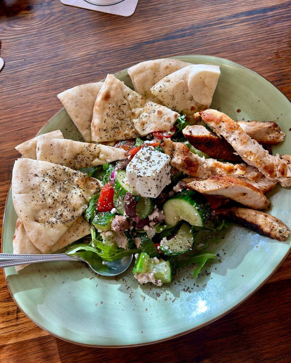 Cretan Dakos Salad ✨ European cucumbers, cherry tomatoes, marinated feta, red onion, capers, Kalamata olives, house-made white balsamic dressing, toasted pita. Add chicken for some protein if you feel like it. It's so flavorful!